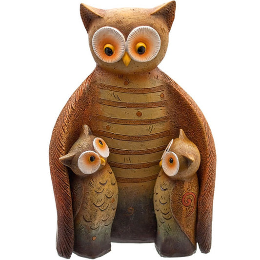 Ceramic owl family figurine on a white background