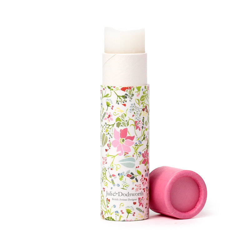Floral-patterned cylindrical container with a pink lid on a white background