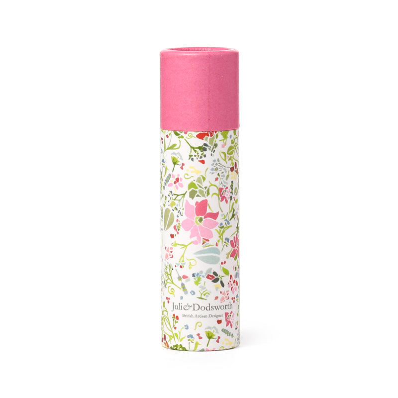  cylindrical product with floral design and pink top on a white background