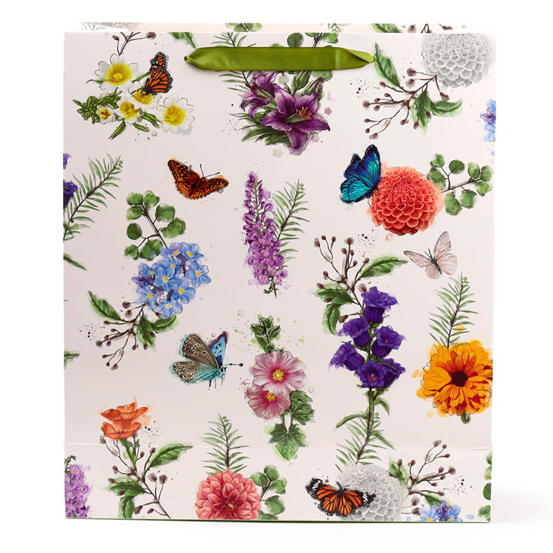 Floral and butterfly patterned gift bag on a white background