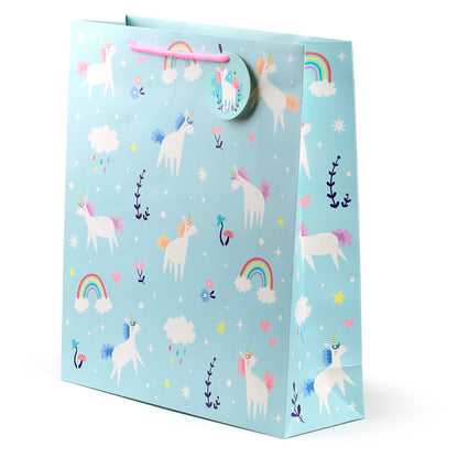 Gift bag with unicorn and rainbow design on a light blue background