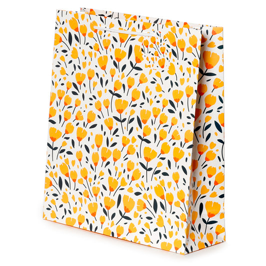 Floral patterned gift bag with yellow flowers and black leaves on a white background