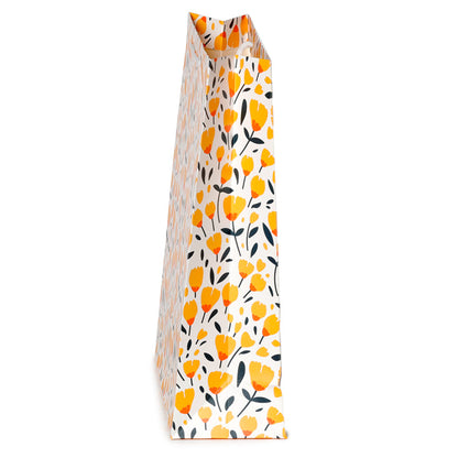Floral patterned gift bag with yellow flowers and black leaves on a white background