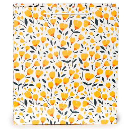 Floral patterned gift bag with yellow flowers and black leaves on a white background