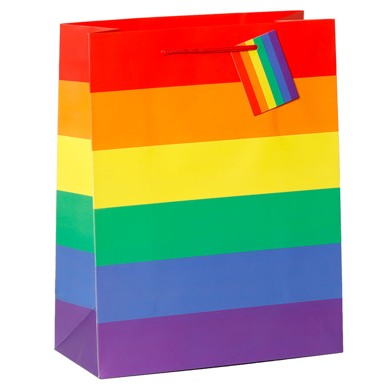 Colourful rainbow-patterned gift bag with a tag on a white background