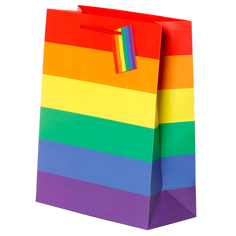 Colourful rainbow-patterned gift bag with a tag on a white background