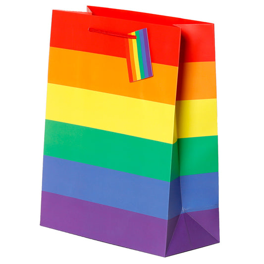 Colourful rainbow-patterned gift bag with a tag on a white background
