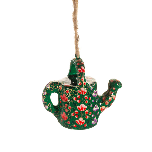 Decorative teapot ornament with floral patterns on a white background