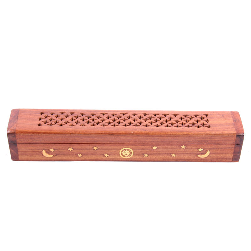 Wooden incense holder with decorative patterns on a white background