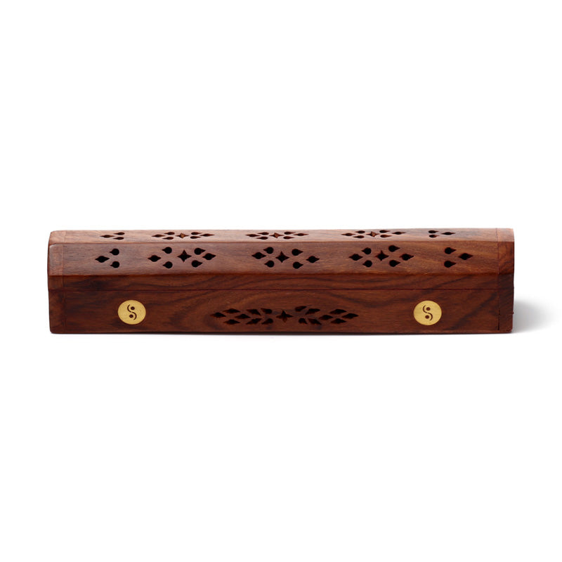 Wooden incense holder with decorative patterns on a white background