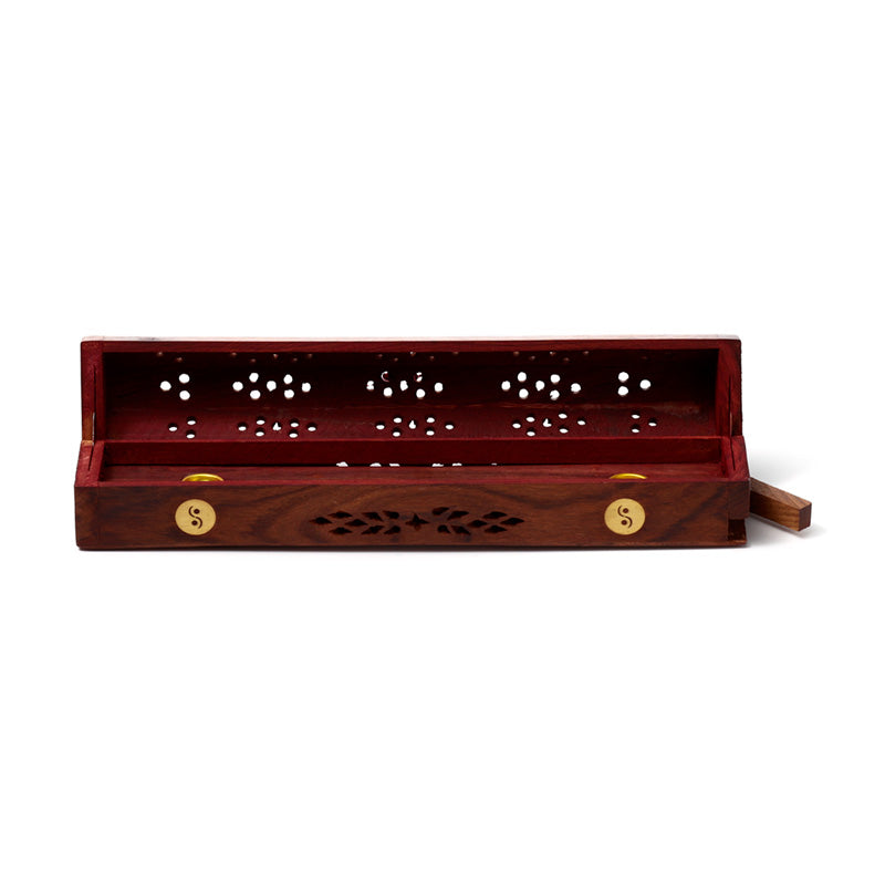 Wooden incense holder with decorative patterns on a white background
