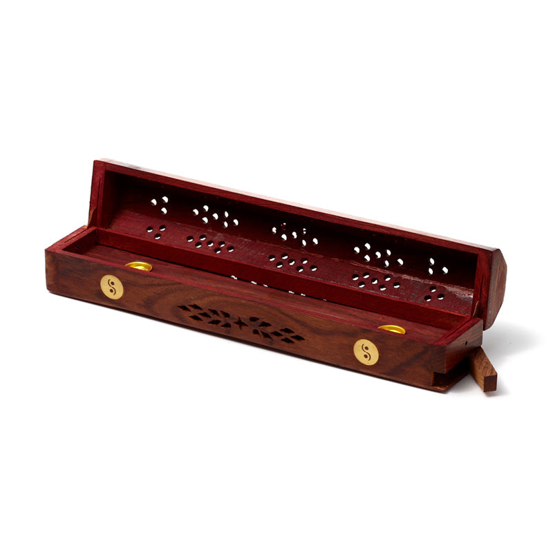Wooden incense holder with decorative design on a white background