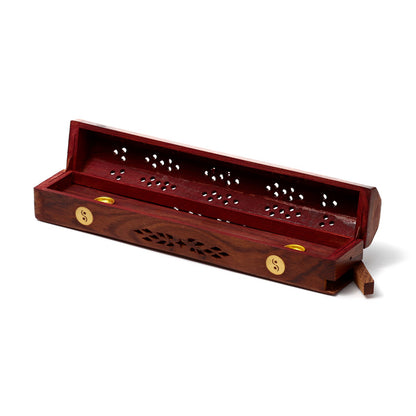 Wooden incense holder with decorative design on a white background