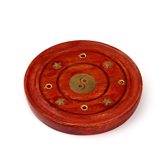 Wooden circular object with brass accents on a white background