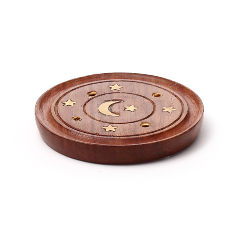 Wooden coaster with star and moon design on a white background