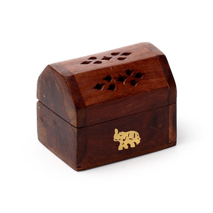 Wooden box with decorative cutouts and a gold elephant emblem on a white background