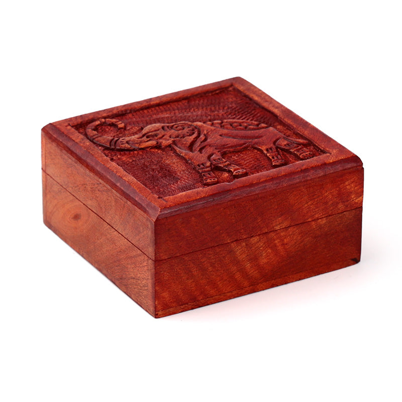 Wooden box with elephant carvings on a white background