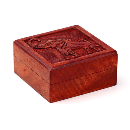 Wooden box with elephant carvings on a white background