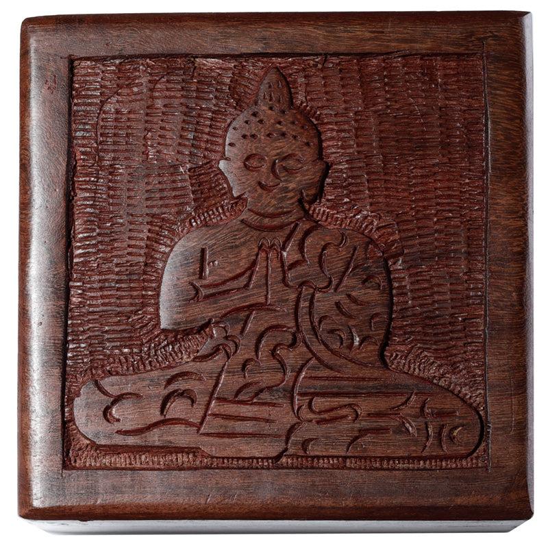 Wooden box with a carved design of a seated figure on a white background