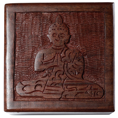 Wooden box with a carved design of a seated figure on a white background
