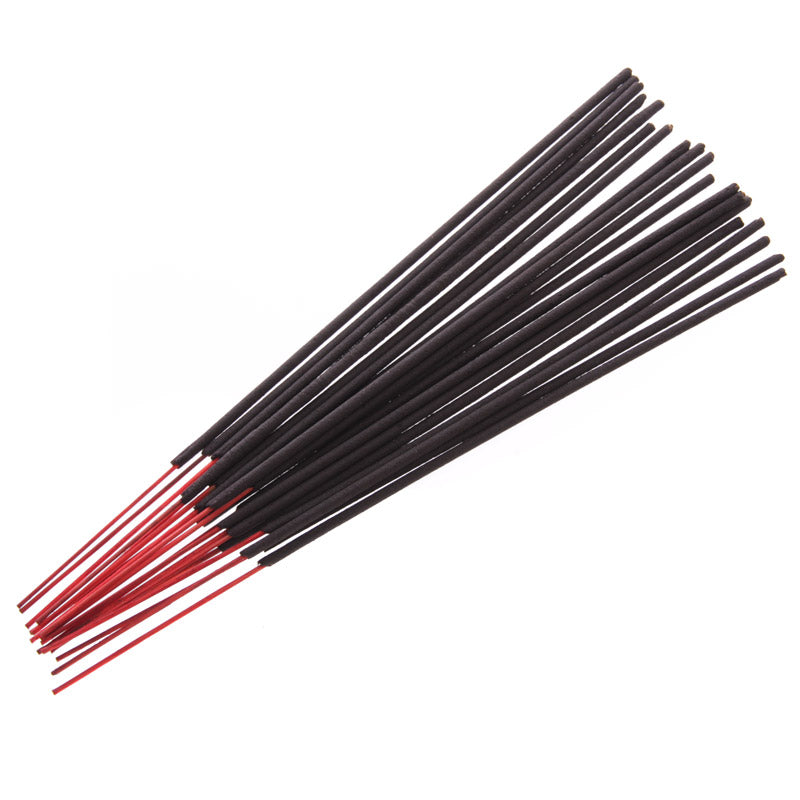 Black and red incense sticks on a white background