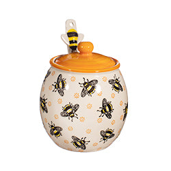 Bee themed honey jar on a white background