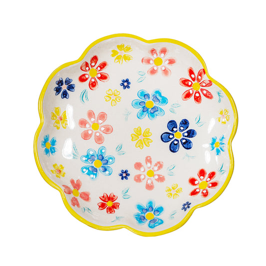 Multi coloured trinket dish on a white background