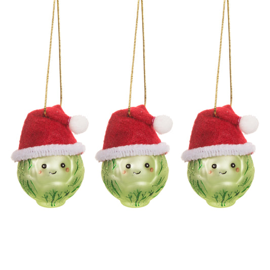 Three green Christmas ornaments with red hats on a white background