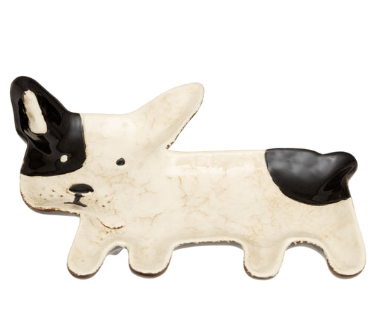 Decorative ceramic dog-shaped object with black and white design on a white background