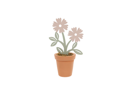 Decorative metal plant with flowers in a terracotta pot on a white background