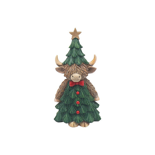 Statue of a highland cow with a Christmas tree on its back, wearing a red bow tie, on a white background.