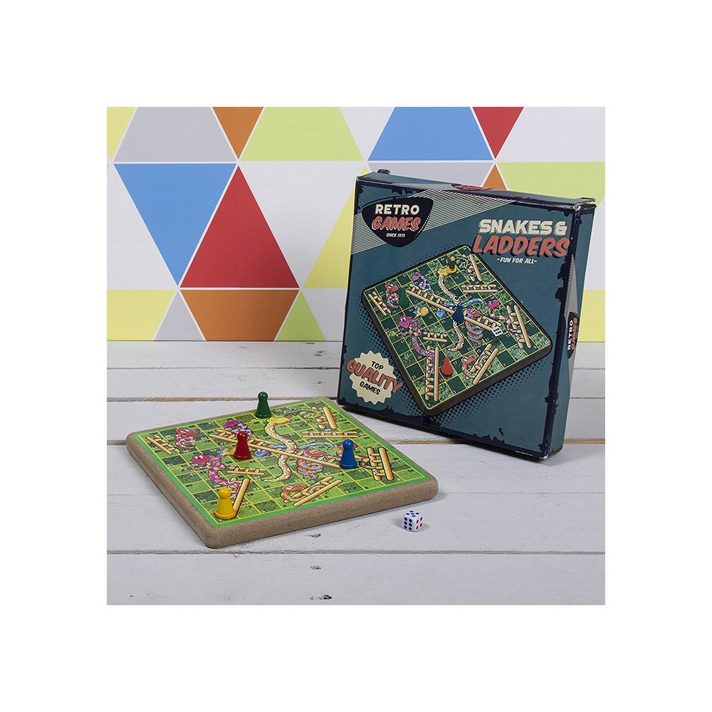 Snakes and Ladders board game with packaging on a wooden surface and geometric background