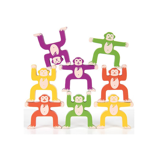 Multiple coloured monkey toys on a white background