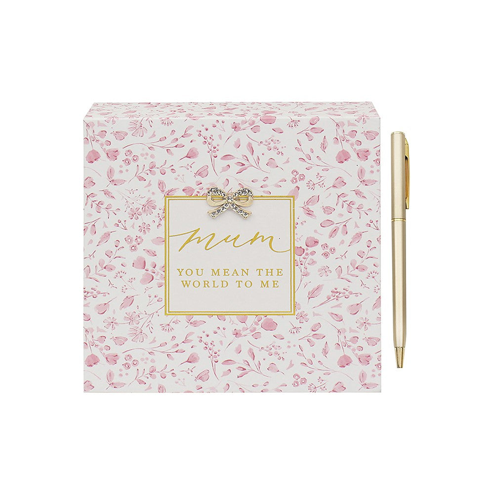 Floral notebook with 'Mum, you mean the world to me' text and a pen on a white background