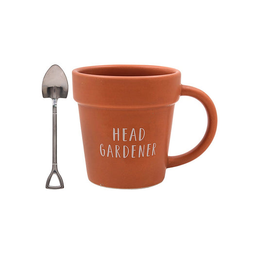 Brown plant pot styled mug with a spade styled spoon on a white background
