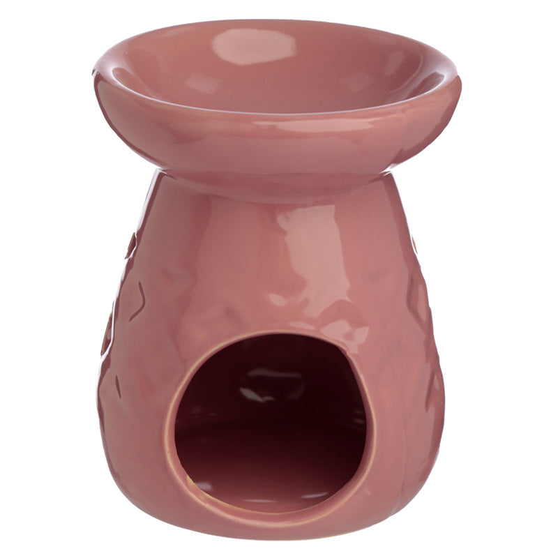 Pink ceramic oil burner on a white background