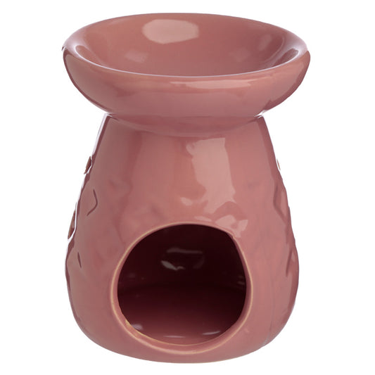 Pink ceramic oil burner on a white background