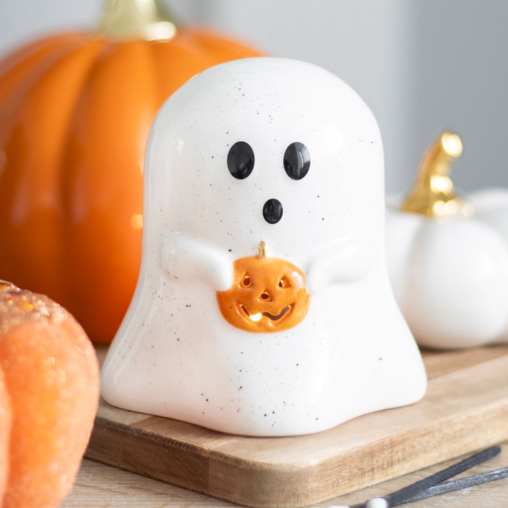 Ghost shaped tealight holder holding a pumpkin