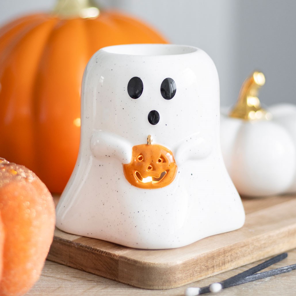 Ghost shaped oil burner holding a pumpkin