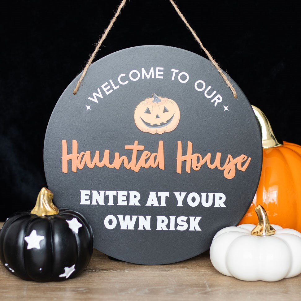 Halloween-themed sign with pumpkins on a dark background