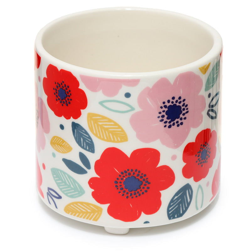 Ceramic pot with colorful floral design on a white background