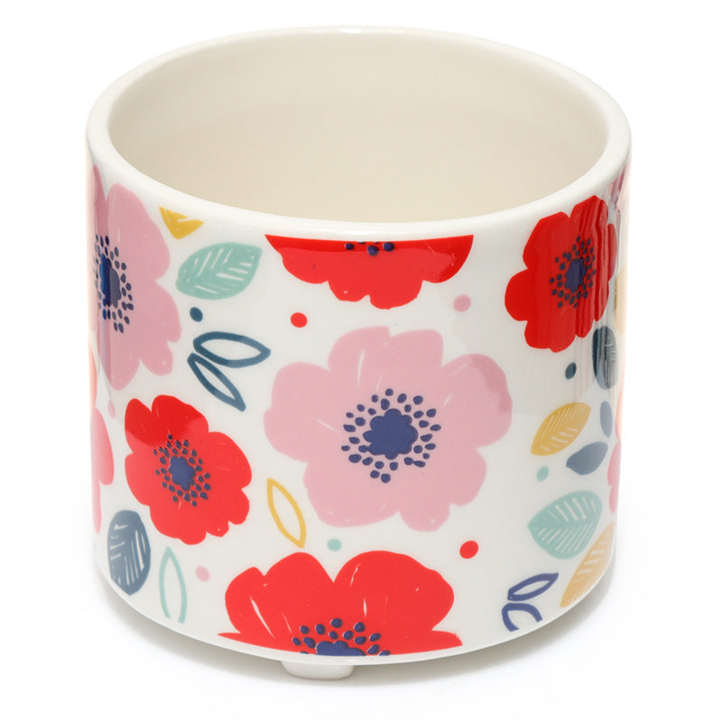 Ceramic pot with colorful floral pattern on a white background