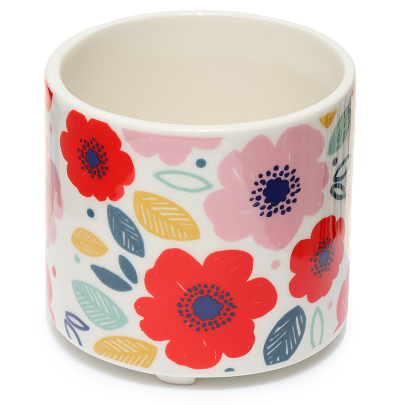 Ceramic pot with colorful floral design on a white background