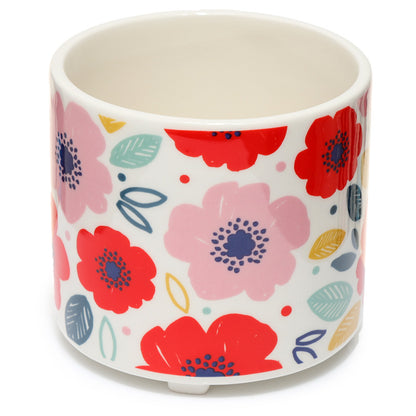 Ceramic pot with colorful floral design on a white background