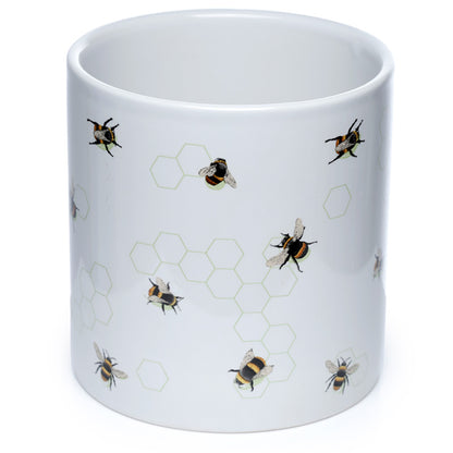 White mug with bee and honeycomb pattern on a white background