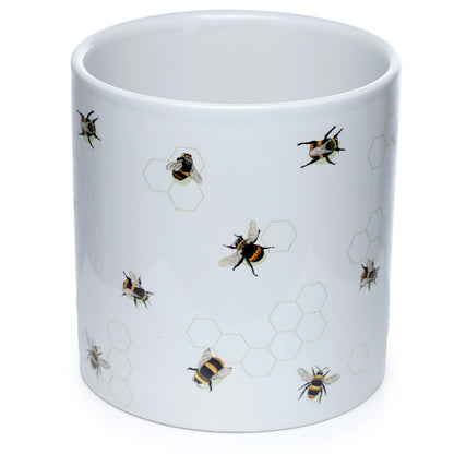 White mug with bee and honeycomb pattern on a white background
