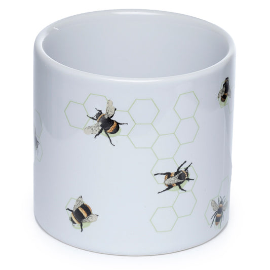White mug with bee and honeycomb pattern on a white background