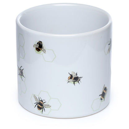 White mug with bee and hexagon pattern on a white background