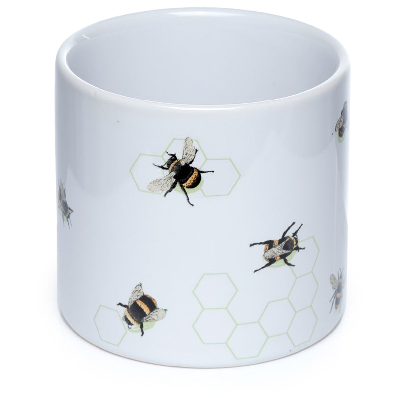 White mug with bee and honeycomb pattern on a white background