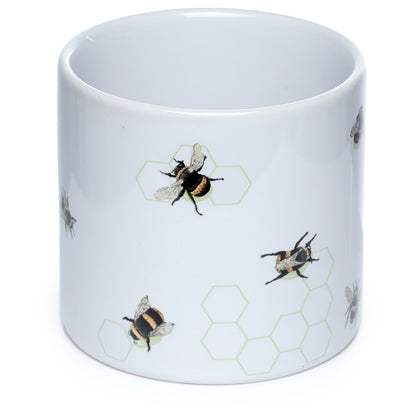 White mug with bee and honeycomb pattern on a white background